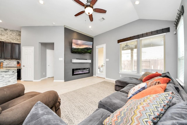 living room featuring ceiling fan and vaulted ceiling