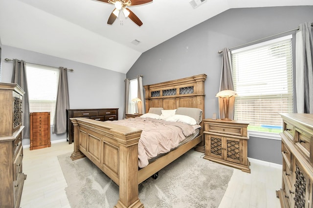 bedroom featuring ceiling fan, vaulted ceiling, and light hardwood / wood-style flooring