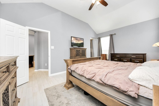 bedroom featuring ceiling fan, light hardwood / wood-style floors, and lofted ceiling