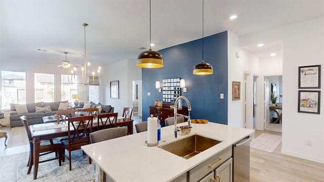 kitchen featuring dishwasher, light hardwood / wood-style floors, an island with sink, ceiling fan, and sink