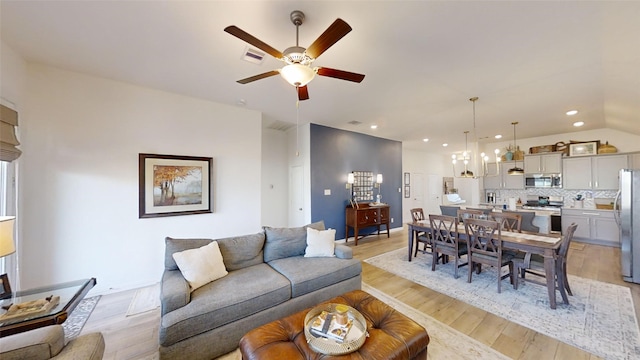 living room with light wood-type flooring and ceiling fan