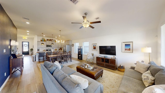 living room featuring ceiling fan and light hardwood / wood-style floors