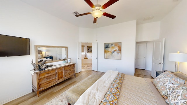 bedroom featuring ensuite bath, ceiling fan, and light hardwood / wood-style floors