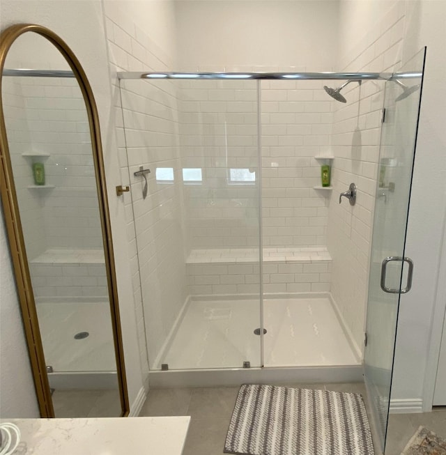 bathroom with walk in shower and tile patterned floors