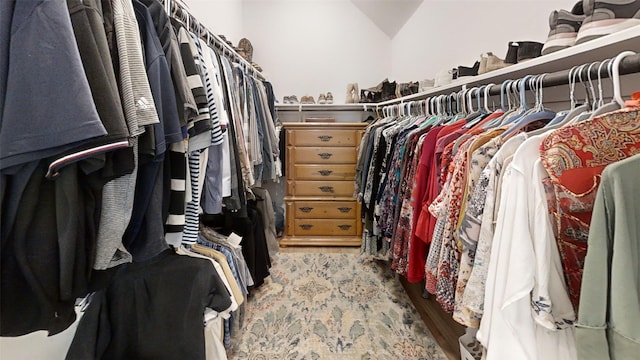 spacious closet with vaulted ceiling and hardwood / wood-style flooring