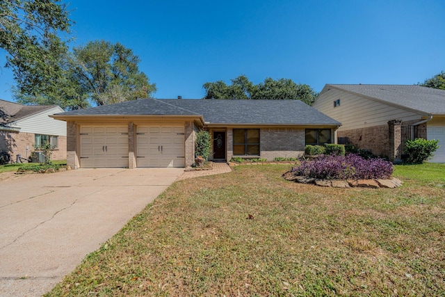 ranch-style house featuring a front yard and a garage