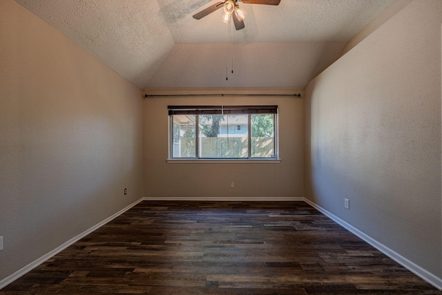 unfurnished room with a textured ceiling, ceiling fan, vaulted ceiling, and dark hardwood / wood-style floors