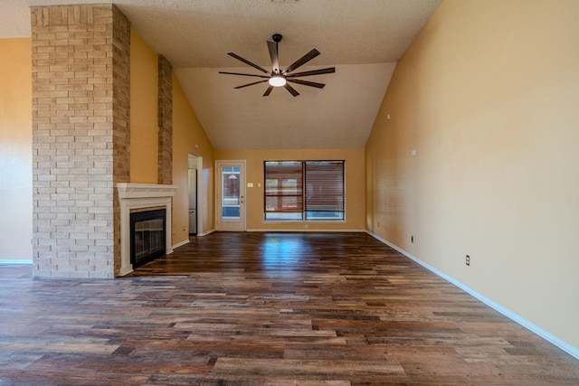 unfurnished living room with a large fireplace, a textured ceiling, dark hardwood / wood-style floors, high vaulted ceiling, and ceiling fan