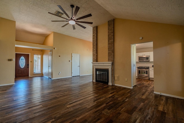 unfurnished living room with dark wood-type flooring, a textured ceiling, high vaulted ceiling, a fireplace, and ceiling fan