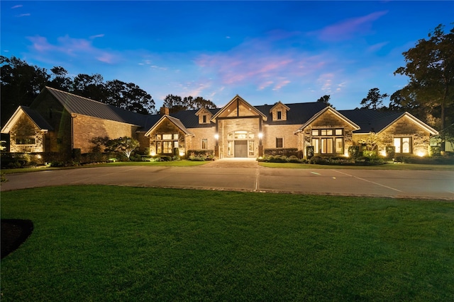 view of front facade with a lawn and french doors