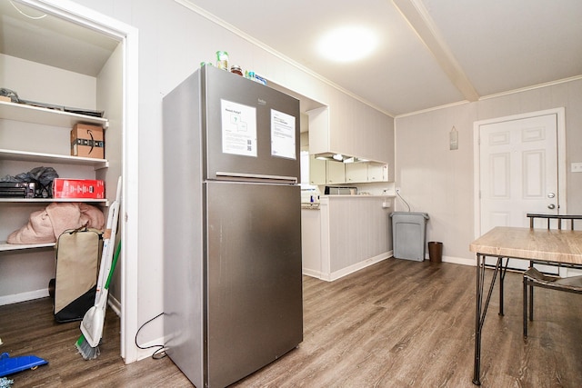 kitchen featuring hardwood / wood-style flooring, stainless steel fridge, and crown molding