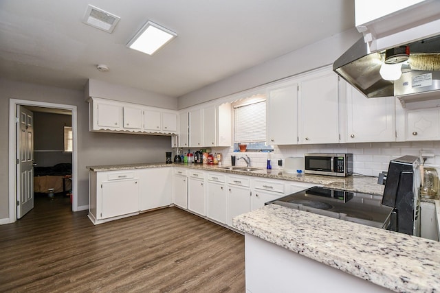 kitchen featuring sink, backsplash, white cabinets, dark hardwood / wood-style flooring, and island exhaust hood