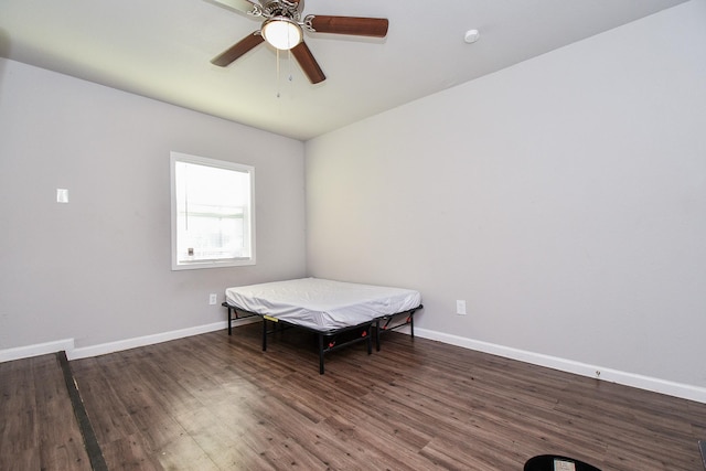 bedroom with dark hardwood / wood-style floors and ceiling fan