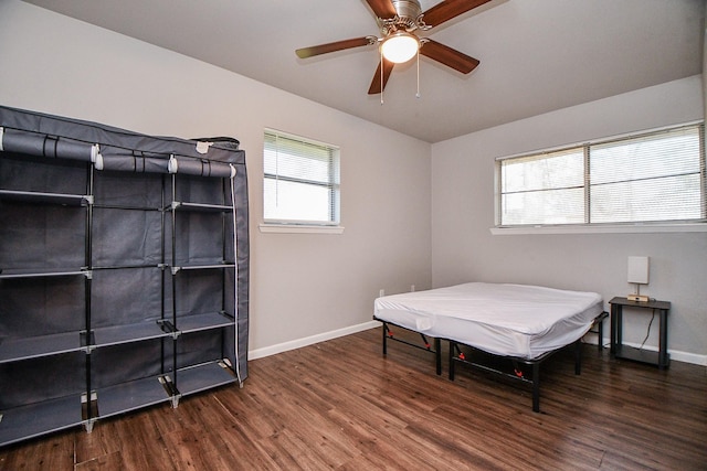 bedroom with ceiling fan and dark hardwood / wood-style floors