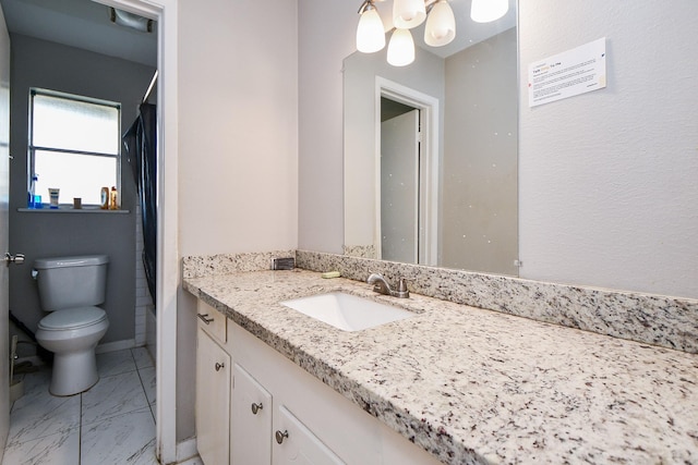 bathroom featuring vanity and toilet