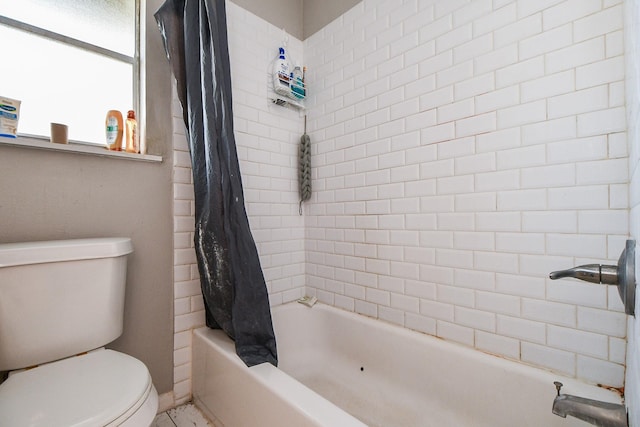 bathroom with toilet and shower / bath combo with shower curtain