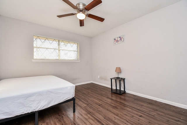 bedroom with dark hardwood / wood-style floors and ceiling fan