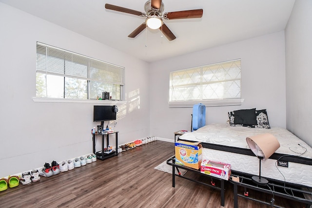 bedroom with dark wood-type flooring, ceiling fan, and multiple windows