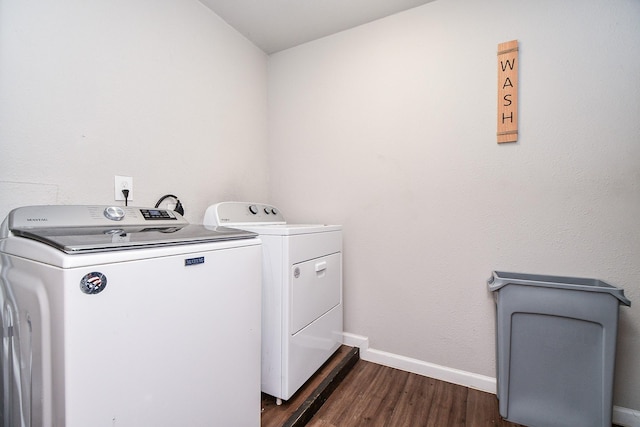 laundry area featuring washing machine and dryer and dark hardwood / wood-style floors