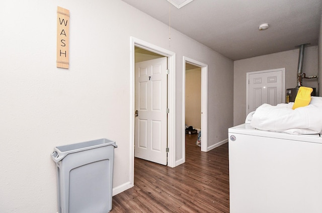 washroom featuring dark hardwood / wood-style flooring and washer / dryer