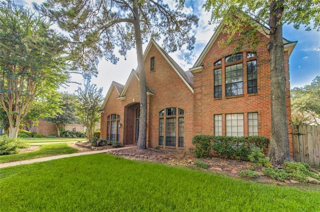 tudor-style house with a front lawn