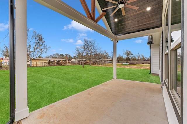 view of yard featuring a patio area and ceiling fan