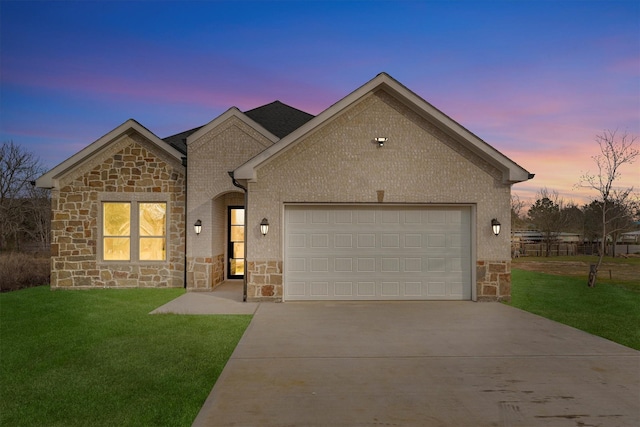 view of front of house with a garage and a yard