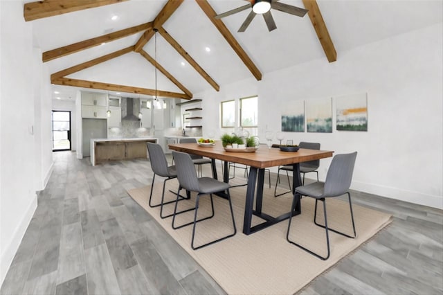 dining space with high vaulted ceiling, ceiling fan, beamed ceiling, and light hardwood / wood-style flooring