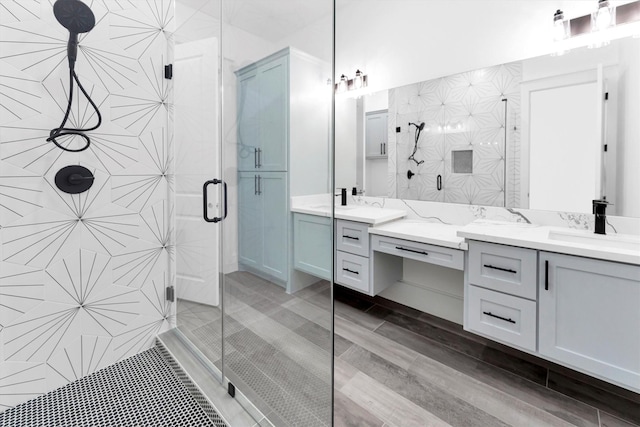 bathroom featuring an enclosed shower and vanity