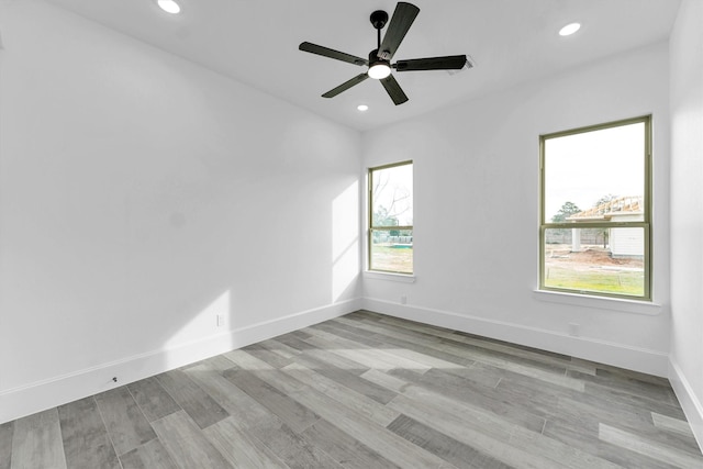 unfurnished room with ceiling fan and light hardwood / wood-style flooring