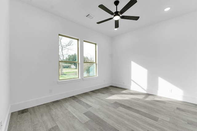 spare room featuring ceiling fan and light hardwood / wood-style floors