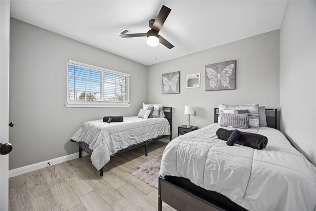 bedroom with ceiling fan and light wood-type flooring