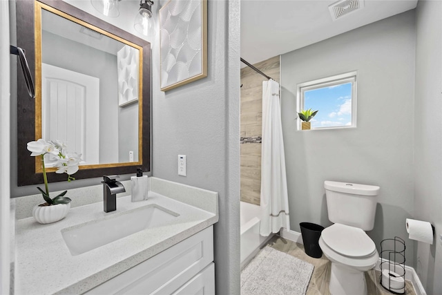 full bathroom with shower / tub combo, hardwood / wood-style floors, vanity, and toilet