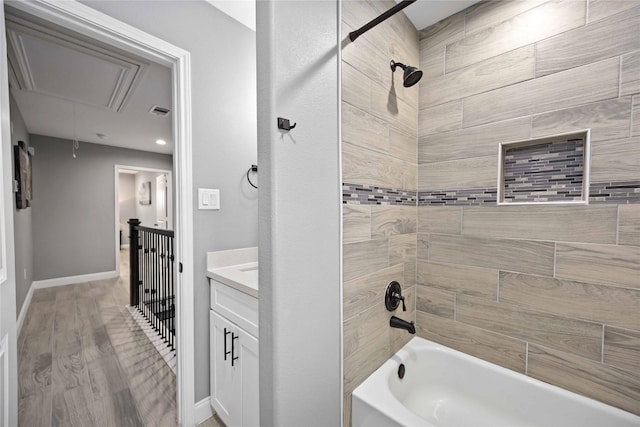 bathroom with tiled shower / bath, wood-type flooring, and vanity