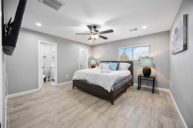 bedroom featuring ensuite bathroom, ceiling fan, and light wood-type flooring