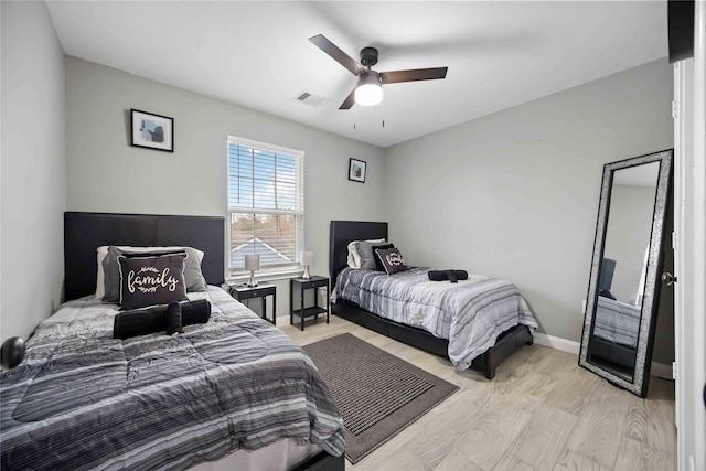 bedroom with light wood-type flooring and ceiling fan