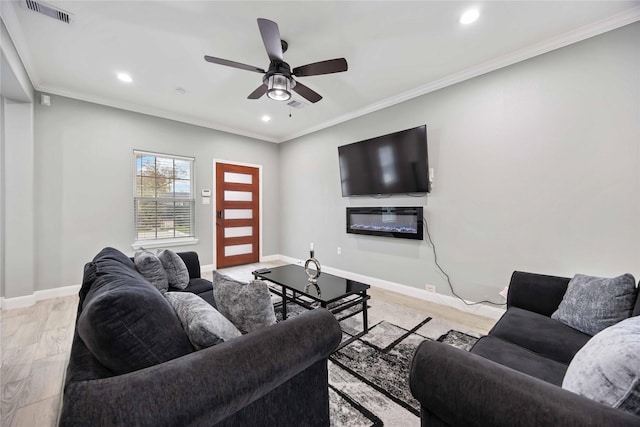 living room with ceiling fan, crown molding, and light hardwood / wood-style flooring