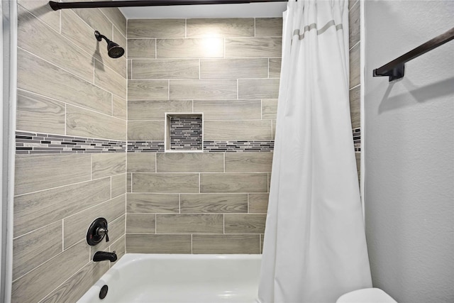 bathroom with shower / bath combo with shower curtain