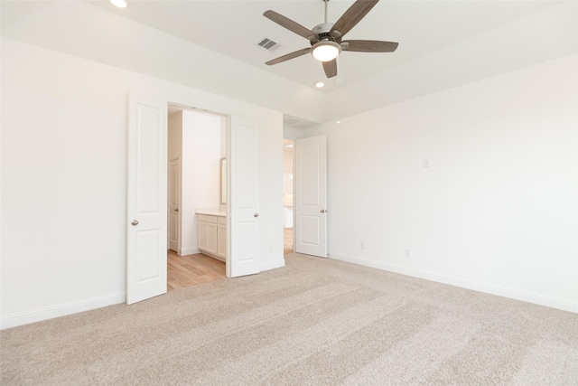 unfurnished bedroom featuring connected bathroom, ceiling fan, and light colored carpet