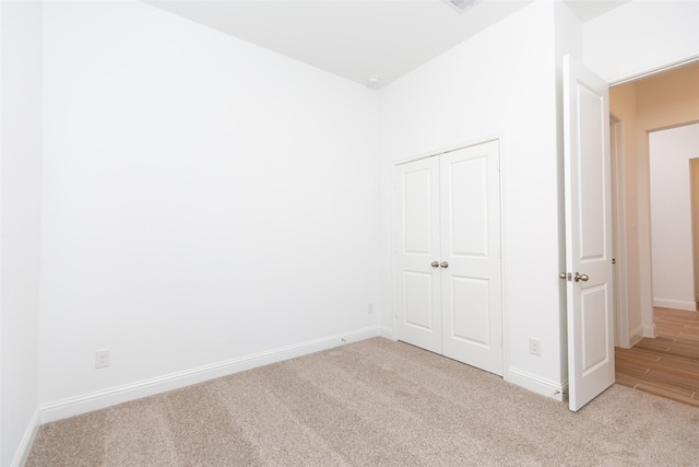 interior space featuring a closet and light carpet