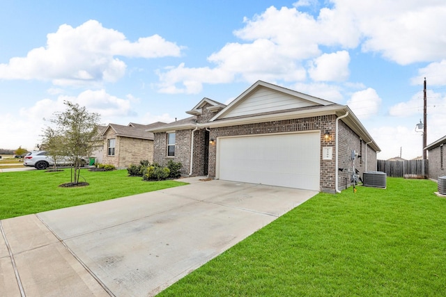 view of front of property featuring a garage, central air condition unit, and a front lawn