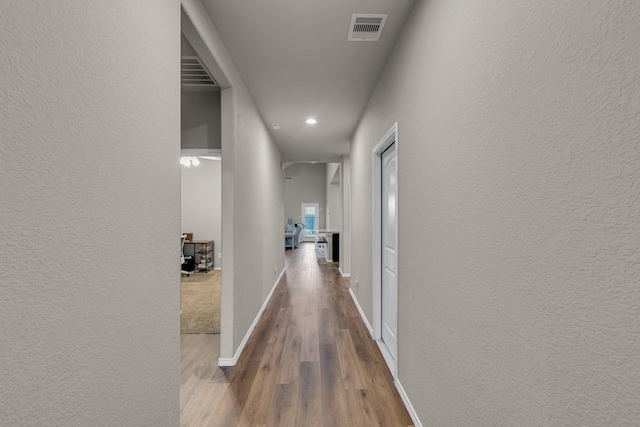 hallway featuring hardwood / wood-style floors