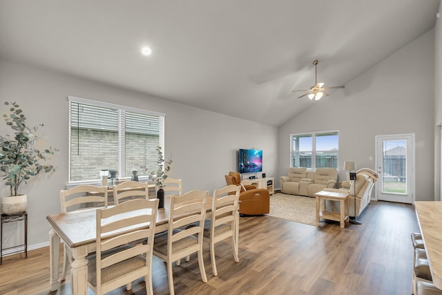 dining area featuring lofted ceiling, ceiling fan, and wood-type flooring