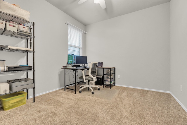 carpeted office space featuring ceiling fan