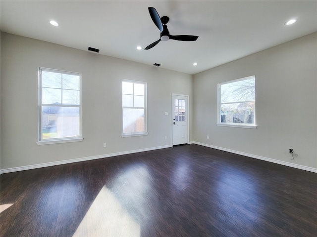 unfurnished room featuring ceiling fan and dark hardwood / wood-style floors