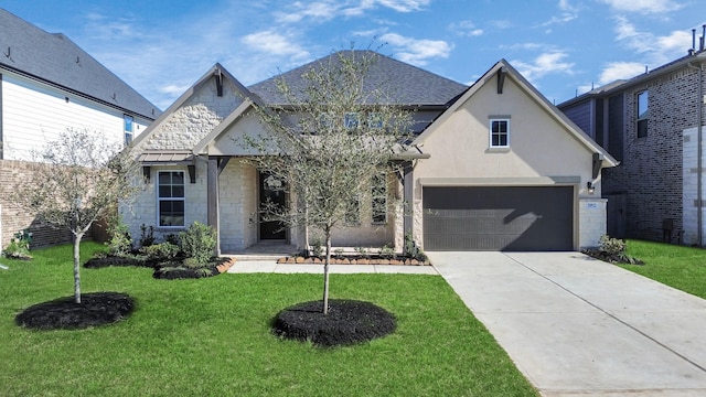 view of front of house with concrete driveway, stone siding, roof with shingles, a front lawn, and stucco siding