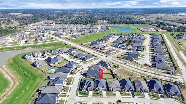 bird's eye view featuring a water view and a residential view