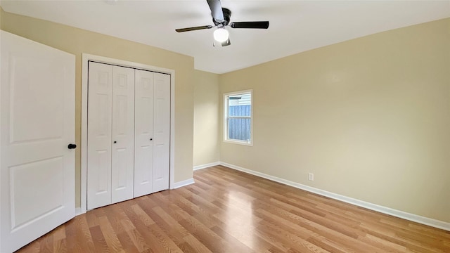 unfurnished bedroom featuring ceiling fan, a closet, and light hardwood / wood-style flooring