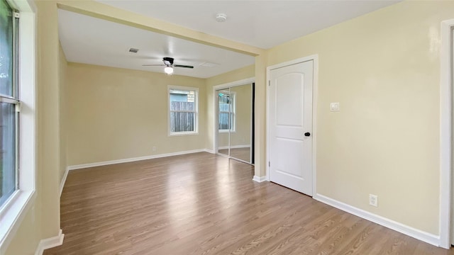 spare room with light wood-type flooring and ceiling fan