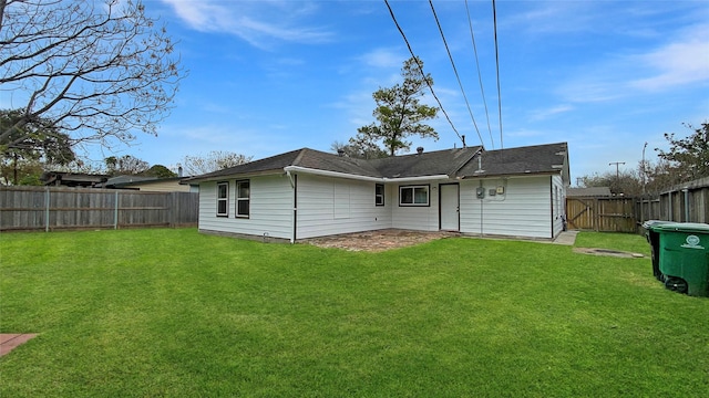 rear view of house featuring a lawn